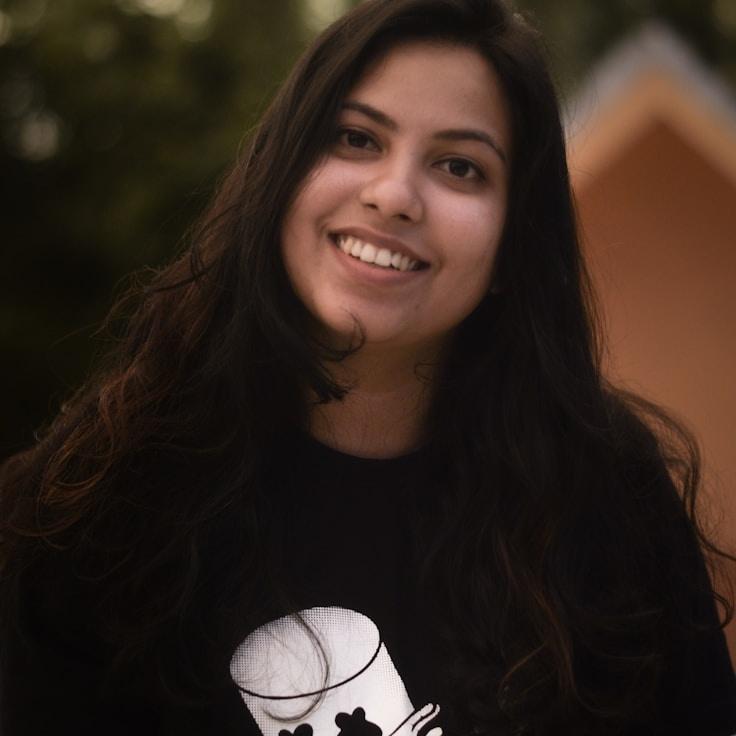 Kaveri Mehta, Lead Design Curator at HavenCalmAnchor, reviewing corporate floral arrangements